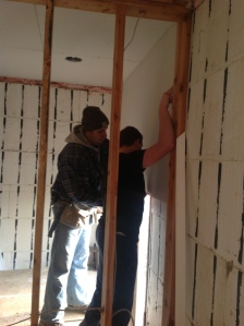 Yay!  Jared and Asher are putting up our first sheet of 1/2inch sheetrock in the main house.  The ceiling is complete and now time for the walls.  